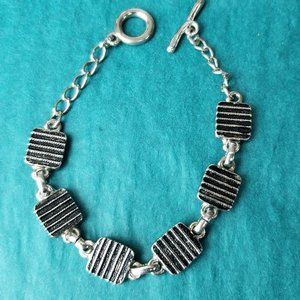 2/10$ Silver tone lined bracelet